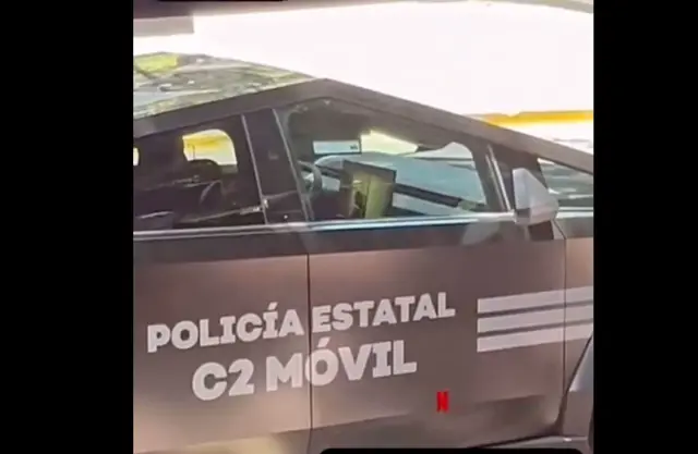 La grabación muestra a los oficiales dentro del vehículo oficial, que cuenta con una pantalla interior, observando contenido audiovisual mientras permanecían estacionados.